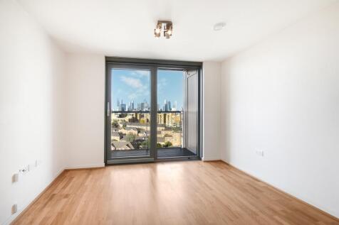 Bright open-plan apartment with private balcony and Canary Wharf views in Greenwich's Creekside development. Modern living with integrated appliances, concierge service, and superb transport links via