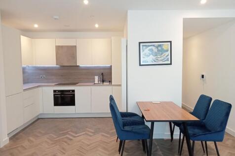 A modern 1-bedroom apartment of River Apartments. Featuring an open-plan living/kitchen area with wood floors, floor-to-ceiling windows, and a large private balcony, bedroom with en-suite shower room.