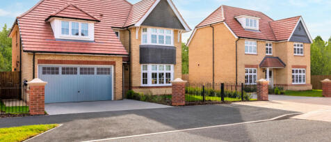 Two modern detached houses with brick and siding exteriors, red tiled roofs, and well-maintained dri