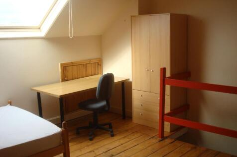 Bright attic bedroom with a large skylight, woo...