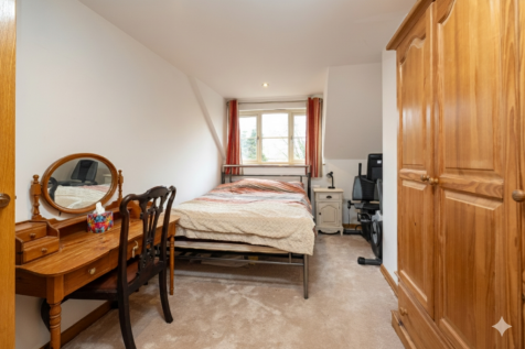 A spacious double bedroom with charming village vi