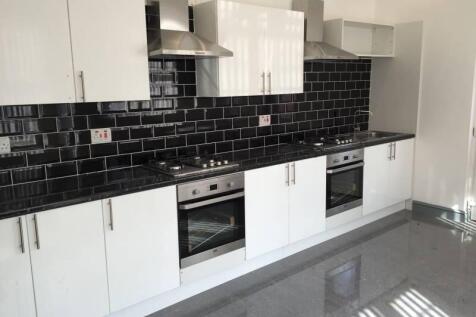 Modern galley-style kitchen with glossy white c...