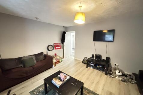 A modern, well-lit living room featuring a comf...