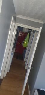 Bright, freshly painted hallway with wood-effec...