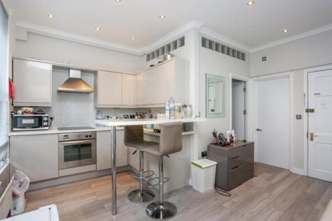 A bright and compact one bedroom apartment on the second floor. Featuring wood floors throughout, an open-plan kitchen and living space, and a modern fitted kitchen with a dishwasher.