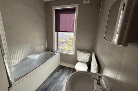 A well-maintained bathroom featuring a bathtub,...