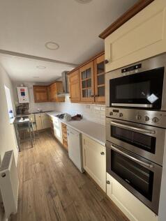 This furnished terraced house on Newlyn Street offers three bedrooms, one bathroom, and a reception room. The kitchen is equipped with modern appliances including a dishwasher, fridge freezer, and was