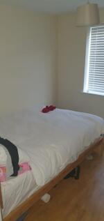 Bright, simply furnished bedroom with a comfort...