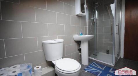 A clean, modern bathroom featuring a large show...