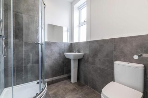 A modern and tidy bathroom featuring a large ba...