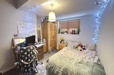 A cozy and inviting bedroom with soft lighting,...