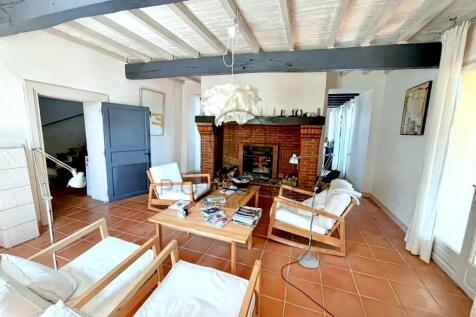 A cozy living room with wooden furniture, a brick