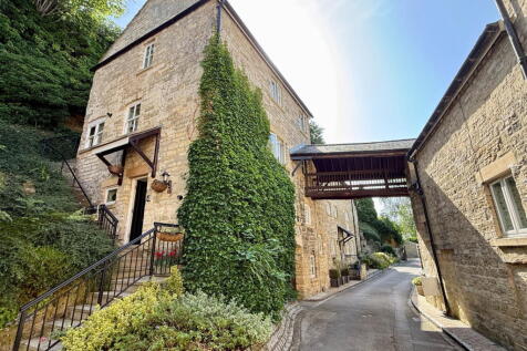 Forming part of a skilful mill conversion, this two/three bedroom Grade II listed period end of terrace home is skilfully arranged over three floors and offers light, spacious accommodation quietly po