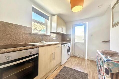 Bright modern kitchen with integrated appliance...