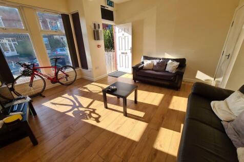 Bright and spacious living room featuring large...