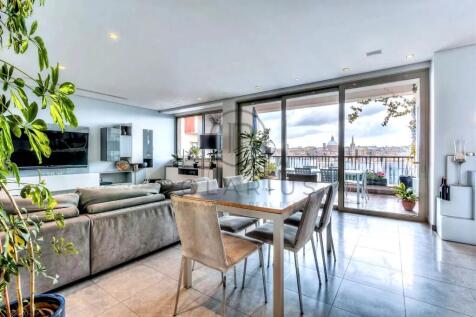 Modern living and dining area with large windows a