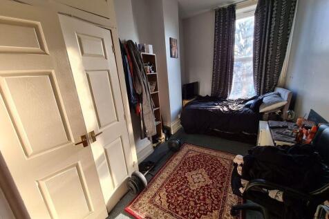 A cozy bedroom featuring a double bed, with nat...